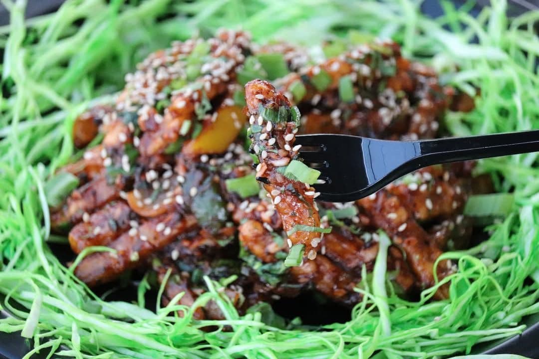 Glazed honey chilli potato on a dark surface, shot by P2V Labs in Ahmedabad